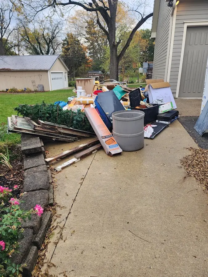 Dumpster being loaded with debris for Roofing Dumpster Rental in West Frankfort